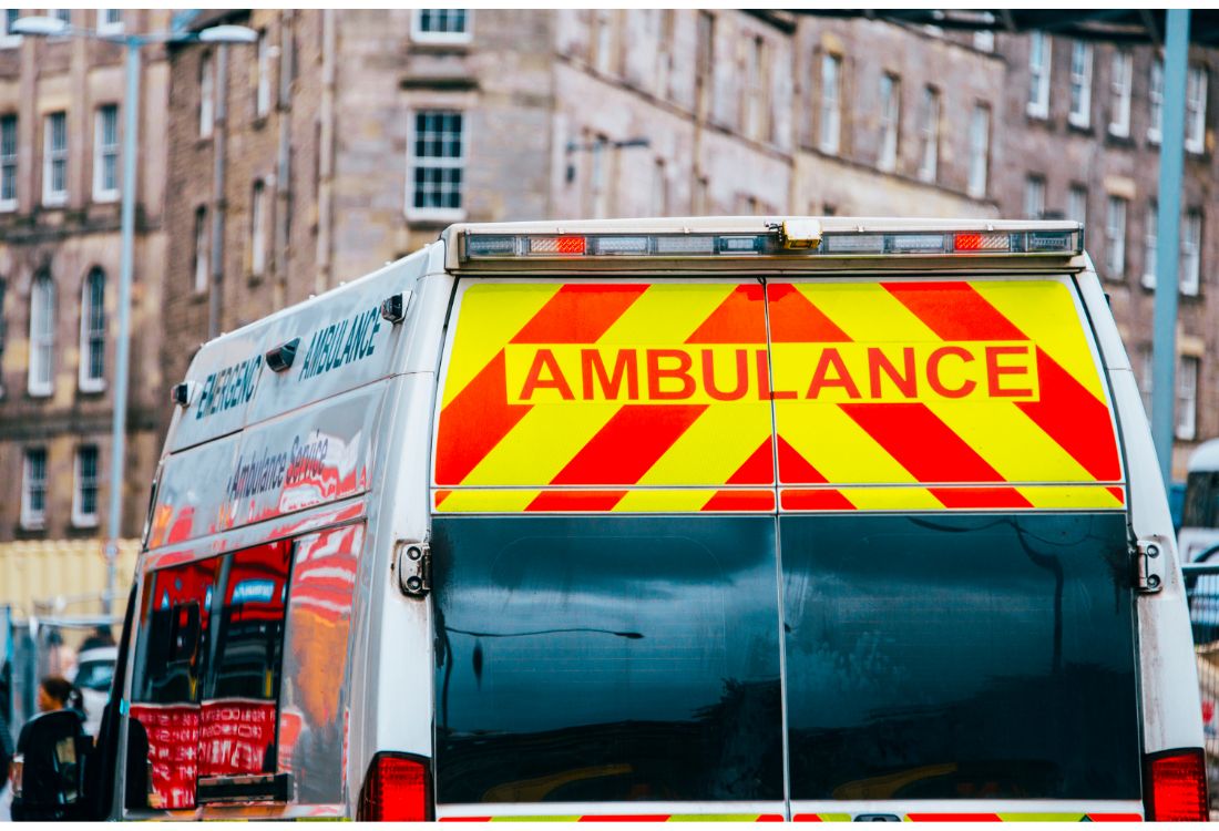 An ambulance transporting a corpse in a body bag, using body bag manufacturers to provide them with the necessary equipment.